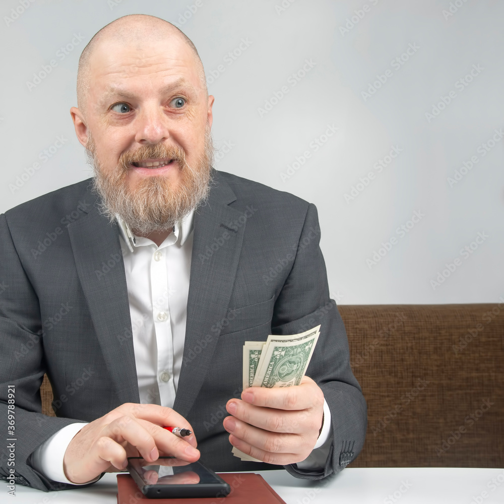 bearded businessman offers payment for work with money against the background of the hourglass. concept of value of time to pay for business