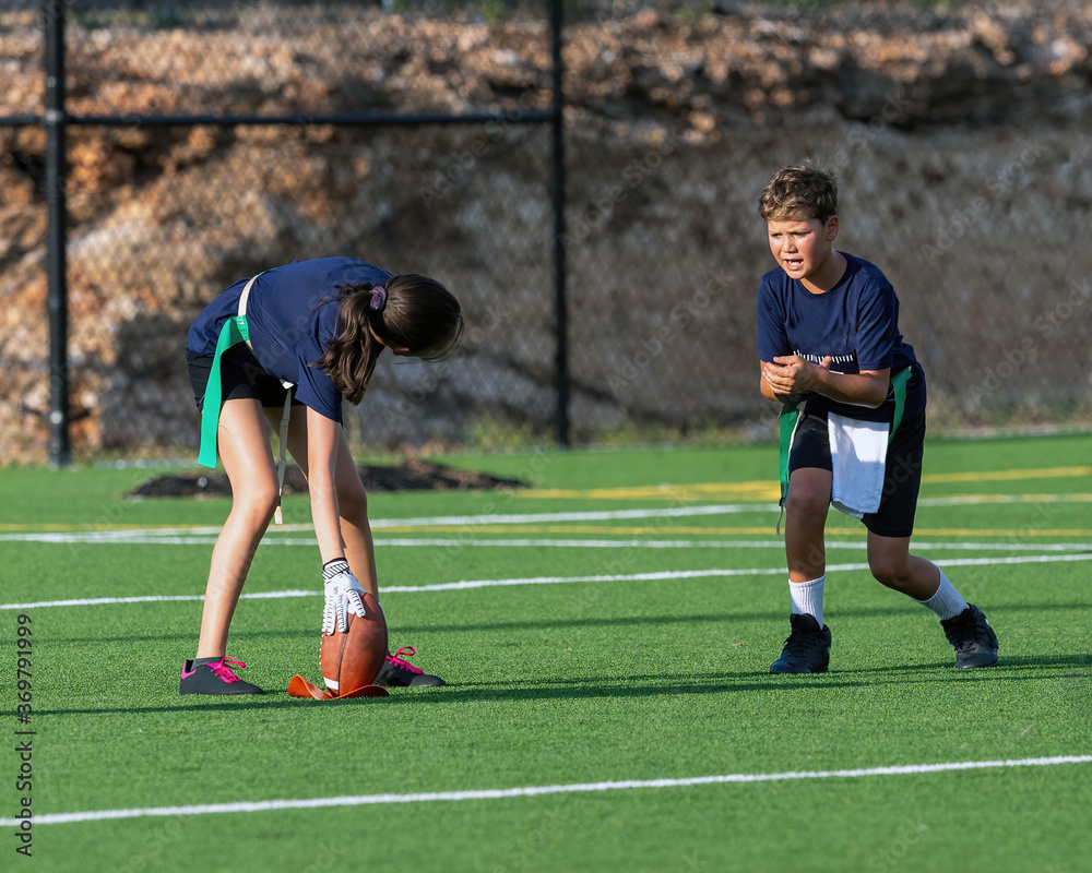 Fototapeta premium Young athletic boy playing in a flag football game