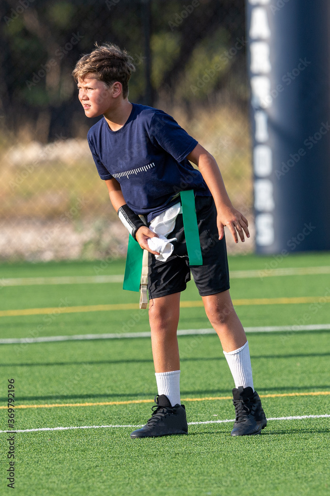 Young athletic boy playing in a flag football game
