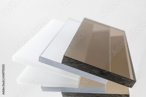 Solid Polycarbonate Sheet. Brown, white, transparent. Acrylic Plastic glass photo