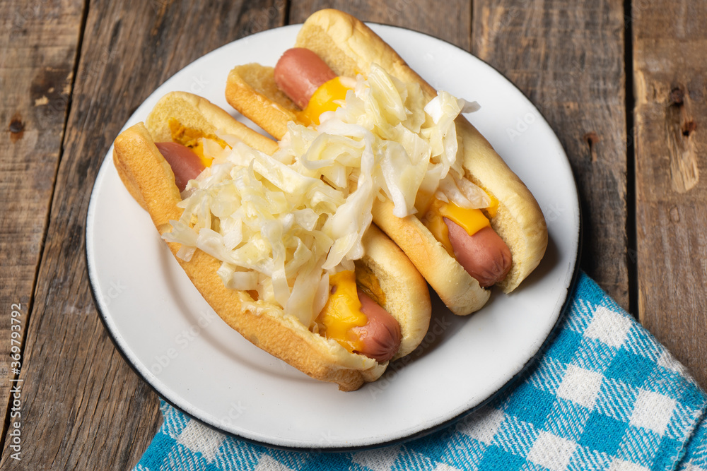 Montreal hot dog with cabbage on wooden background Montreal hot dog with cabbage on wooden background