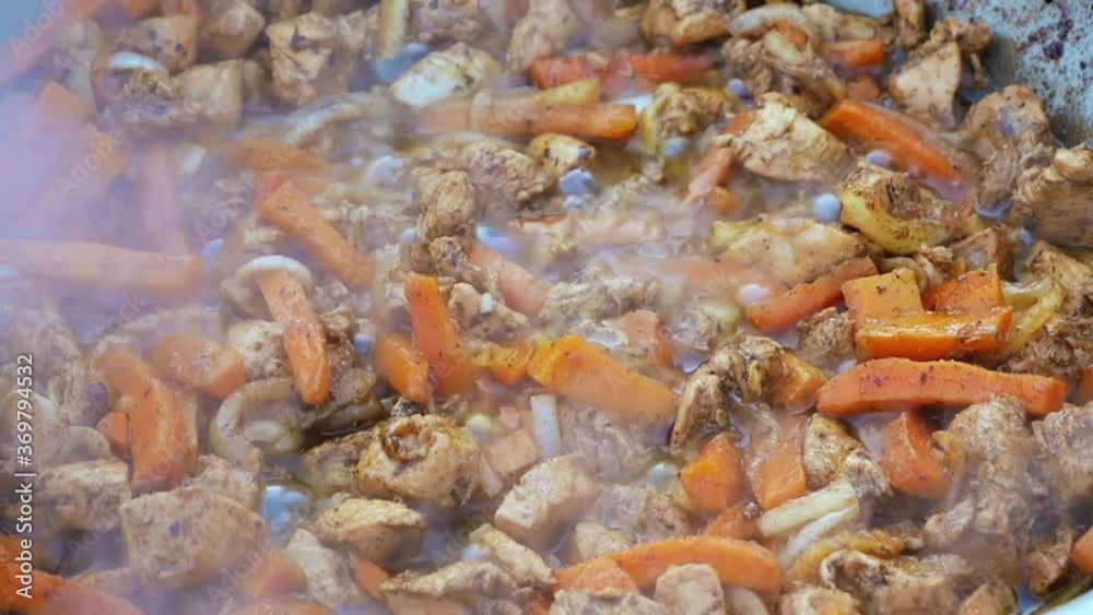 A series of the process of cooking pilaf in a cauldron on the street. handmade oriental cuisine. frying onions and vegetables, adding meat A series of the process of cooking pilaf in a cauldron on the street. handmade oriental cuisine. frying onions and vegetables, adding meat
