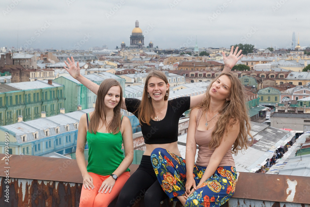 Girls in yoga clothes laughing on the roof
