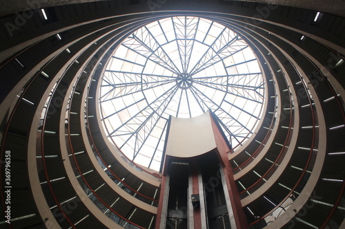 Inside of a circular shopping mall showing the many different levels which can be walked to the top and the windows