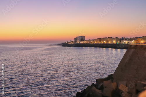 The orange sun sets over the horizon. Atlantic Ocean. Spain