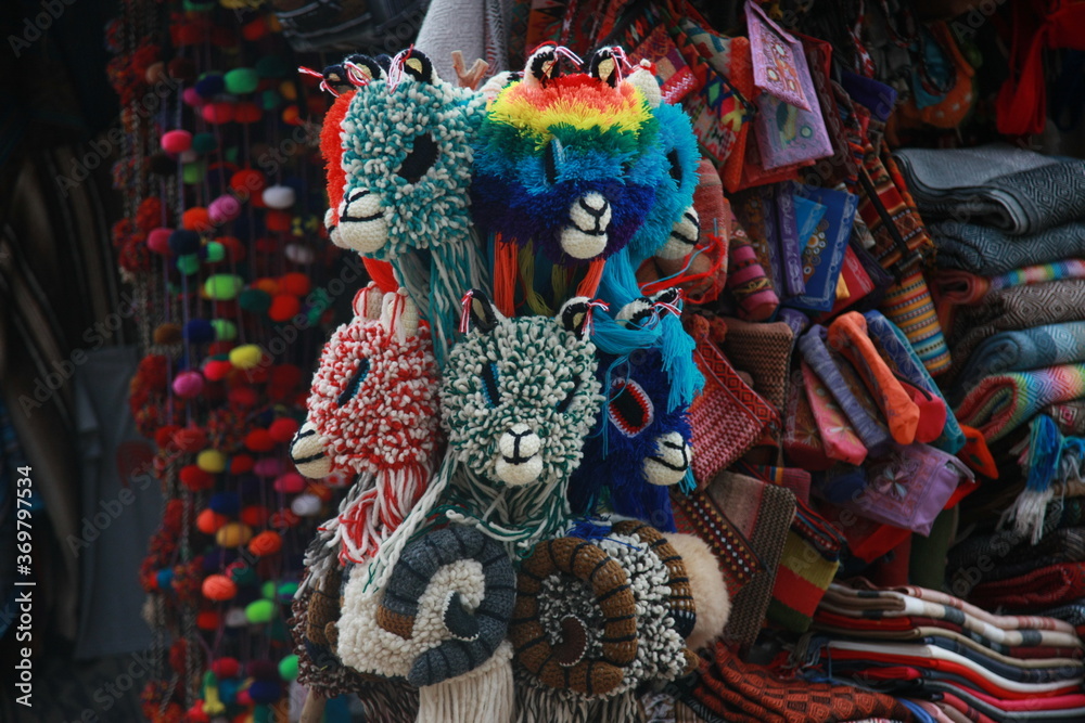 A close up of hats in the shape of lama heads with different colors and shapes