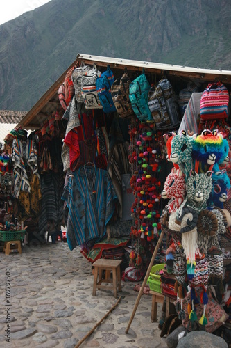 A market stand in the andean mountains full of typical andean clothing, hats and bags © pangamedia