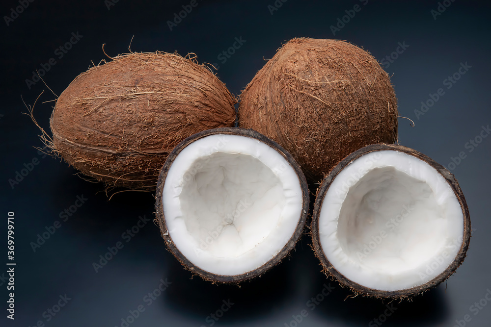 cut fresh coconut on a dark background. vitamin fruits. healthy food