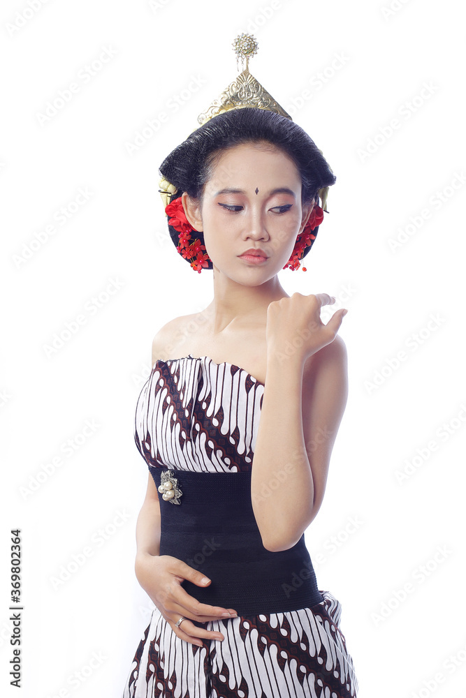 Beautiful Young Woman with bright makeup. a woman using traditional javanese lurik batik and bun on hair