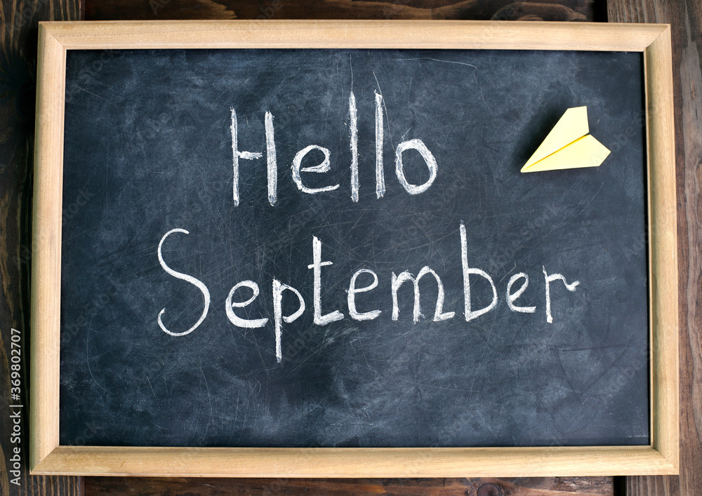 Fototapeta premium Chalk writing on a slate board. Hello September.