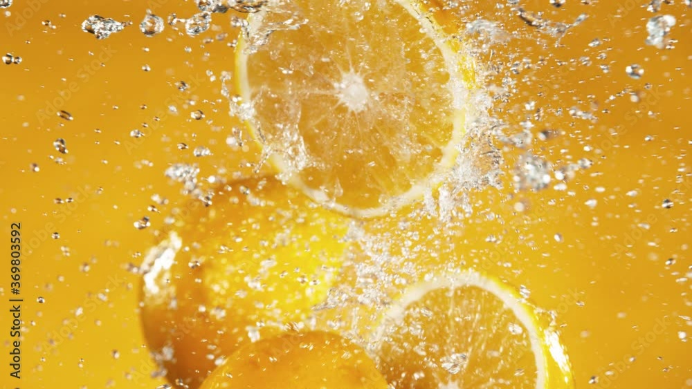 Super slow motion of orange slices collision with water splashes. Filmed on high speed cinema camera, 1000 fps.