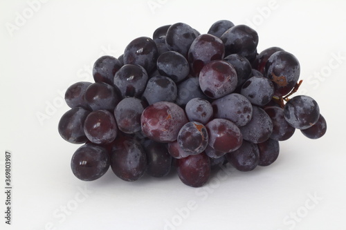 Bunches of dark grapes isolated on white background.