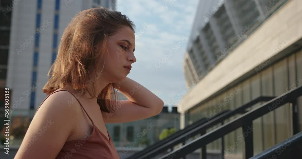 Beautiful brunette young woman model wearing brown dress and posing on the street. Beautiful brunette young woman model wearing brown dress and posing on the street.