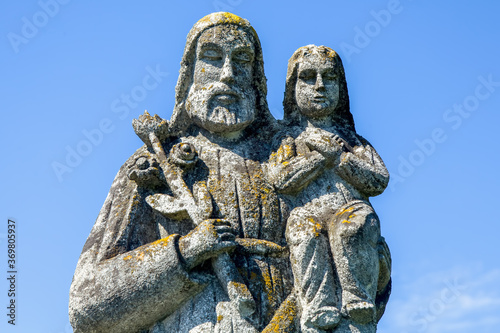 Saint Joseph with little Jesus Christ. Ancient statue.