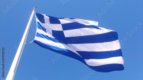 Flag of Greece waving over a blue sky in Athens