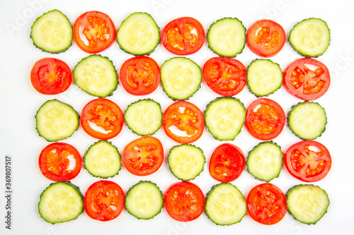 sliced ​​pieces of cucumber and tomato on a white background. fast food and breakfast