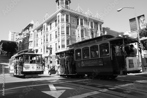 Classic view of historic traditional Cable Cars riding on famous California Street, San Francisco, in black and white, monochrome.