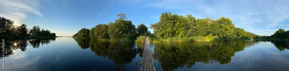panoramic photo of a hanging bridge over the river