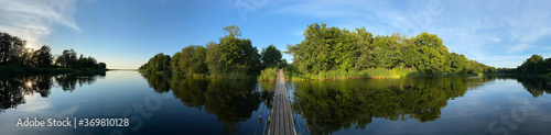 panoramic photo of a hanging bridge over the river