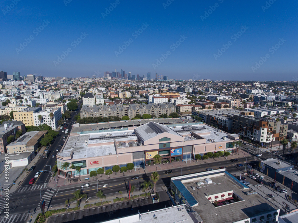 Aerial city view drone photo toward Downtown LA Los Angeles from Western Ave and 8th St around Koreatown Plaza Market