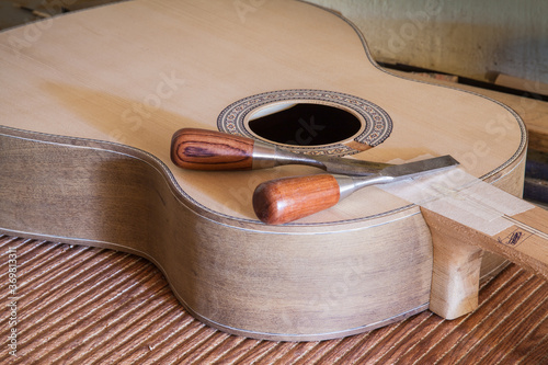 Classical guitar under construction in luthier workshop photo