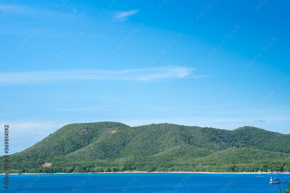 Photo of ocean and hills on blue sky
