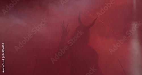Succubus is lurking in the red smoke, creepy demon silhouette, 4k