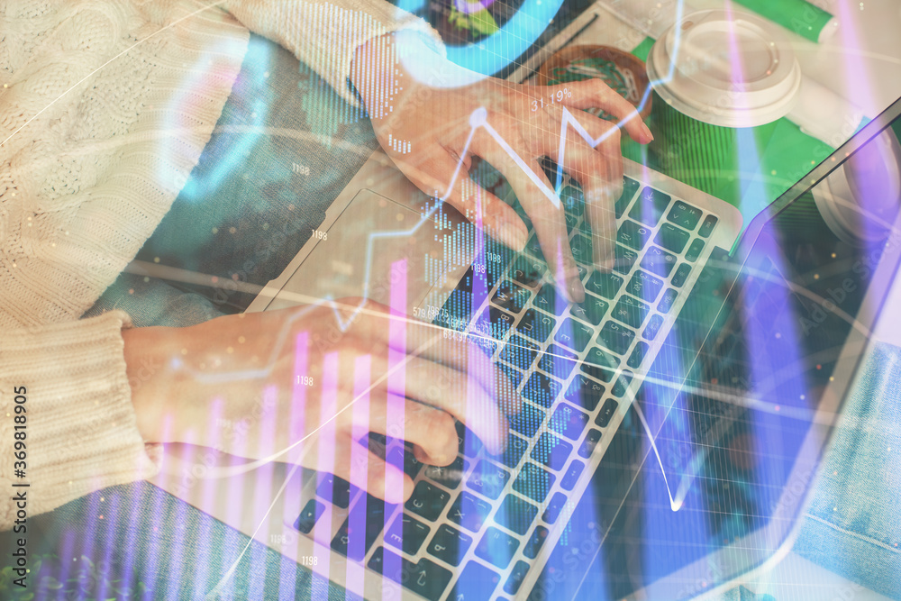 Double exposure of woman hands typing on computer and forex chart hologram drawing. Stock market invest concept.