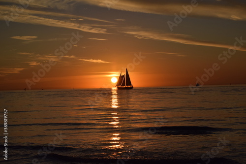 Silhouette of a sailboat against the sunset at clearwater beach