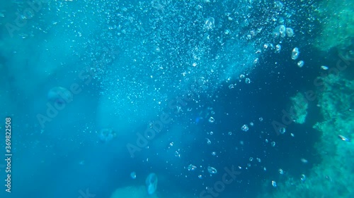 Fethiye, Turkey - 30th of July 2020: 4K Plenty of small air bubbles rise up from the scuba divers at the deeps

