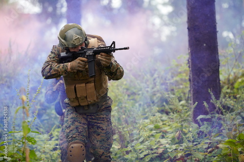 soldier in action aiming  on weapon  laser sight optics