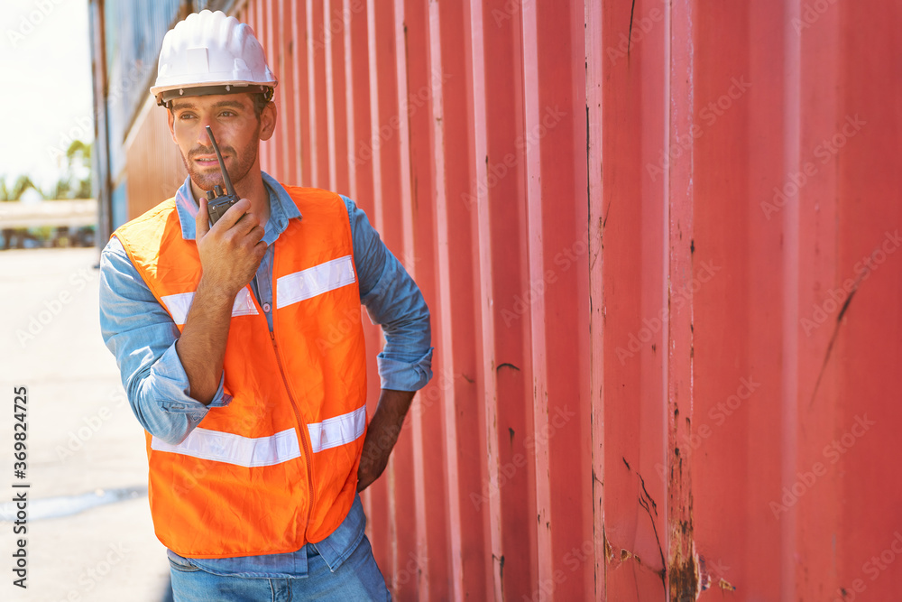 portrait foreman use walkie talkie beside red box container portrait foreman use walkie talkie beside red box container