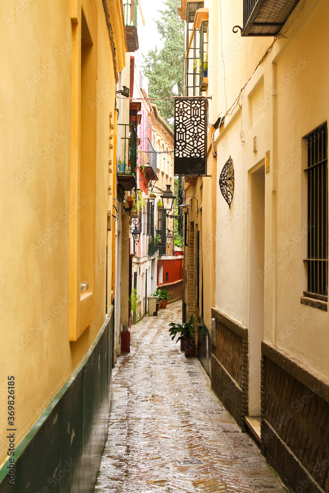 Naklejka premium a narrow street situated in the center of the spanish city sevilla