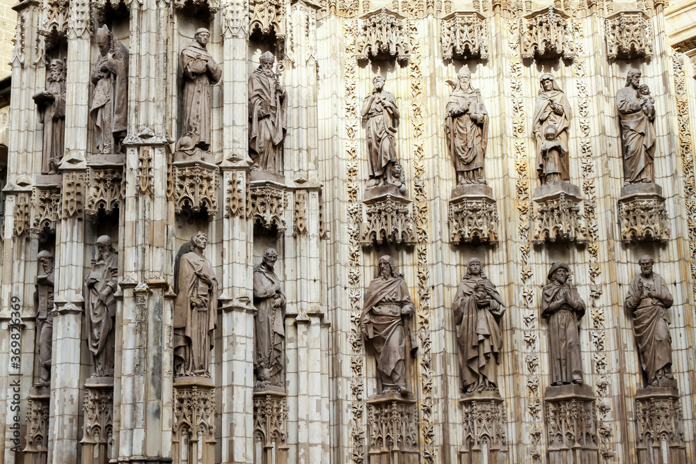 Detail of some of the statues of bishops, saints, and martyrs outside the cathedral of Seville in Spain.