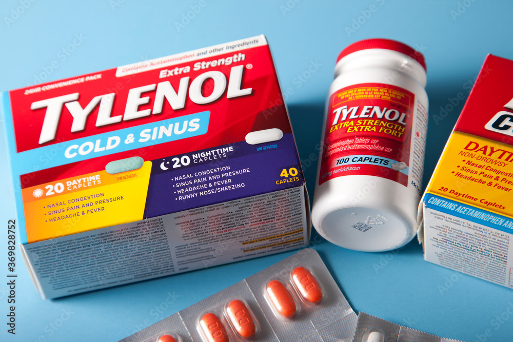 Tylenol cold and sinus, pain relief and nighttime pills against a blue