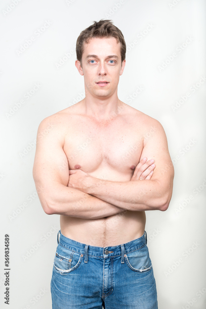 Portrait of handsome shirtless man against white background