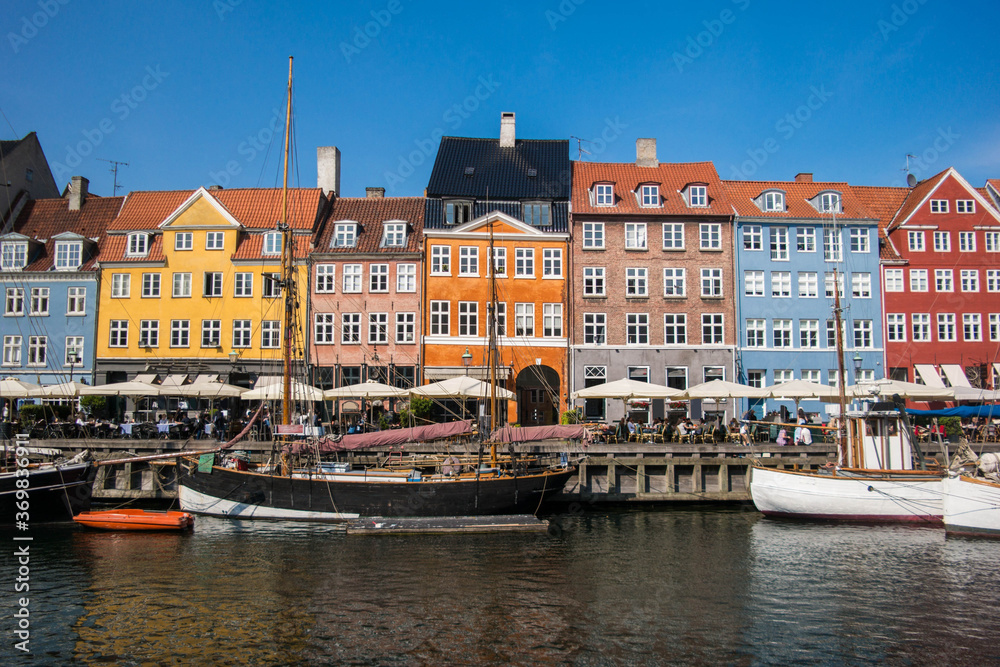 Fototapeta Buildings and the canal of Nyhavn district in Copenhagen, Denmark, panoramic view of Nyhavn