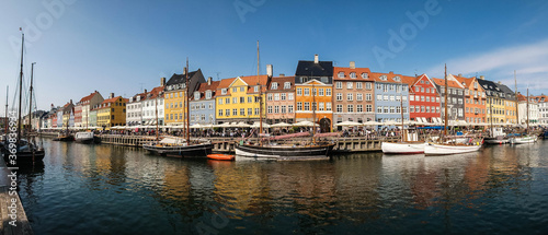Buildings and the canal of Nyhavn district in Copenhagen, Denmark, panoramic view of Nyhavn