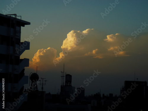 The summer setting sun which glares down in a thunderhead