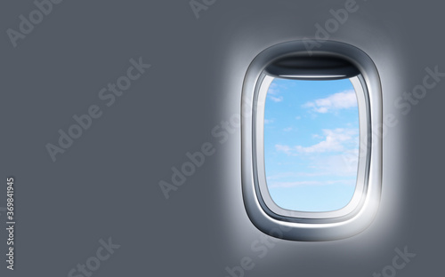 View on blue sky through open airplane porthole. Space for text