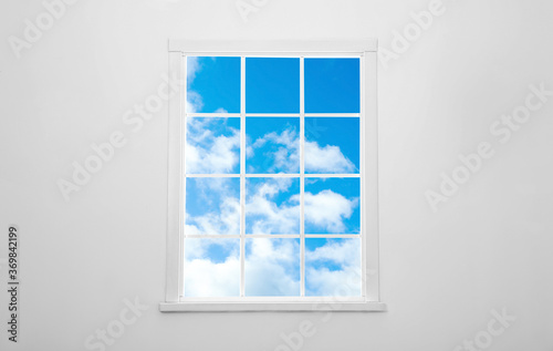 Beautiful view on blue sky with clouds through window