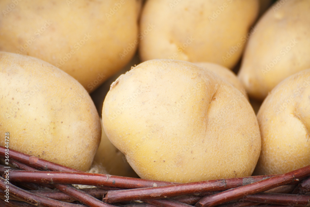 Fresh ripe various potatoes in basket on stall at bazaar Fresh ripe various potatoes in basket on stall at bazaar