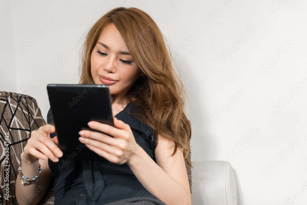 Young beautiful Asian woman in the living room at home Young beautiful Asian woman in the living room at home