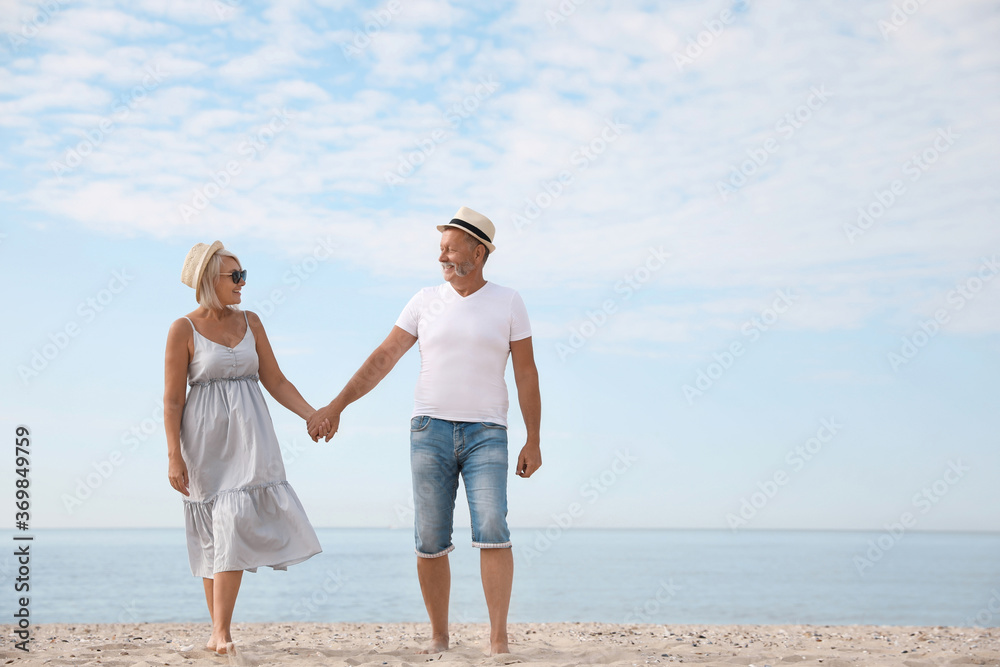 Mature couple spending time together on sea beach Mature couple spending time together on sea beach