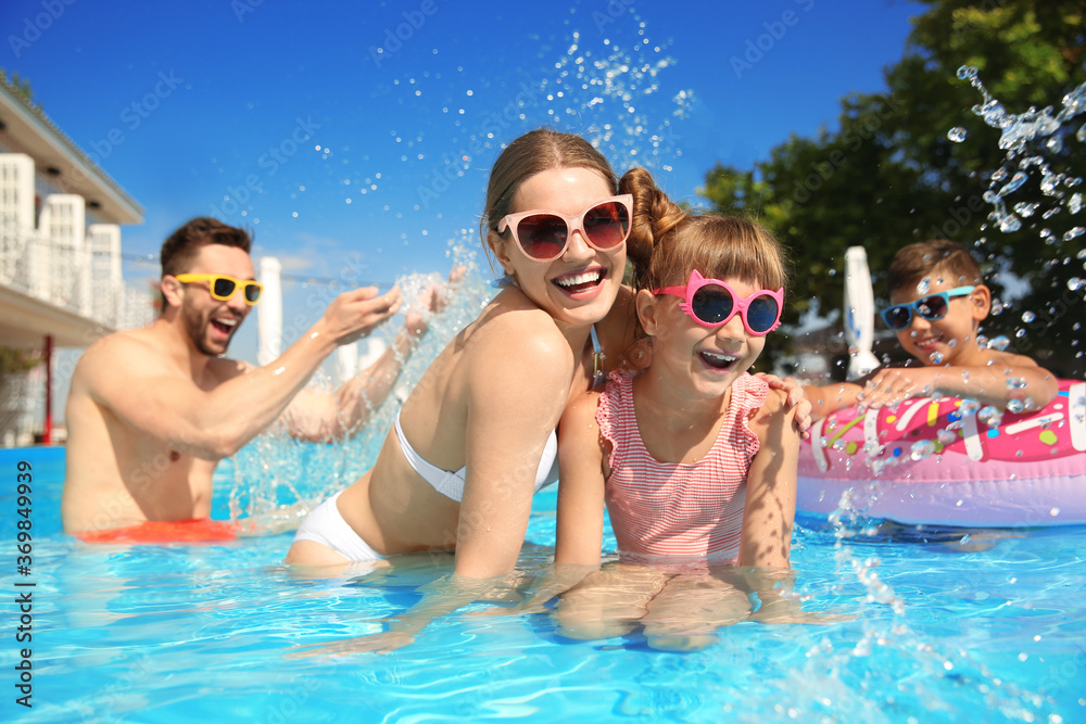 Happy family having fun in swimming pool Happy family having fun in swimming pool