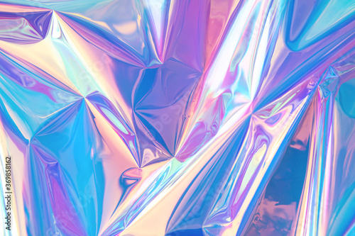 Blurred abstract Modern pastel colored holographic background in 80s style. Crumpled iridescent foil real texture. Synthwave. Vaporwave style. Retrowave, retro futurism, webpunk photo