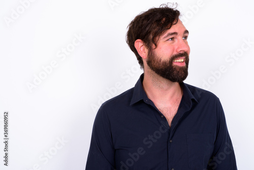 Portrait of happy handsome bearded businessman against white background