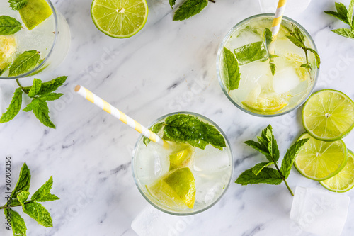 Lime and mint drink Mojito cocktail or mocktail with paper straws, seen from above