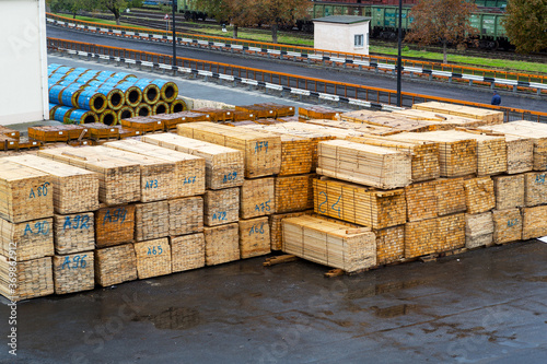 Odessa, Ukraine - October 13, 2016: Industrial products, raw materials, timber and sheet steel mill in the industrial port quay shopping ready for loading cargo seagoing vessels