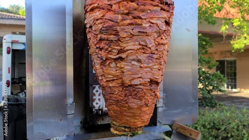 Tacos al pastor in spinning grill or shawarma grill photo